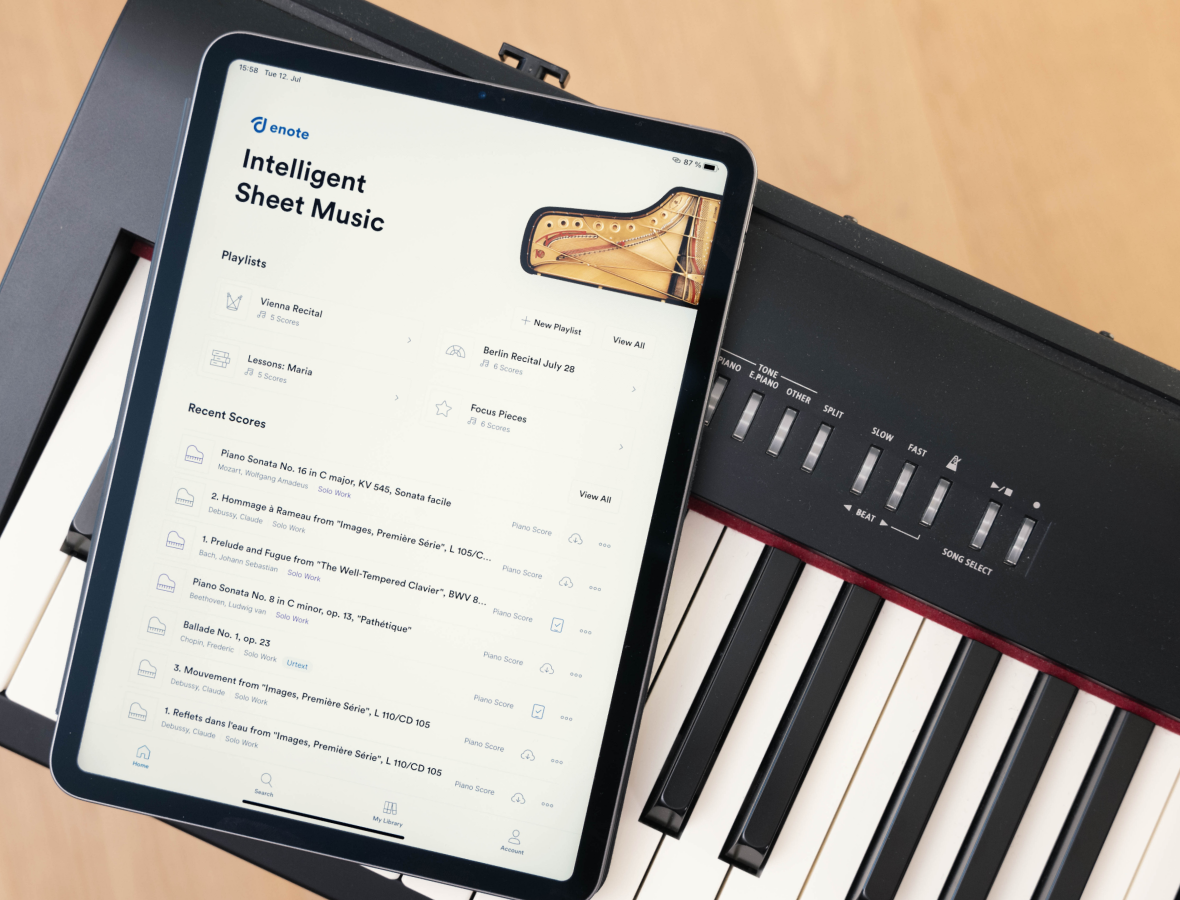 An iPad showing the Enote home screen on top of a digital piano
